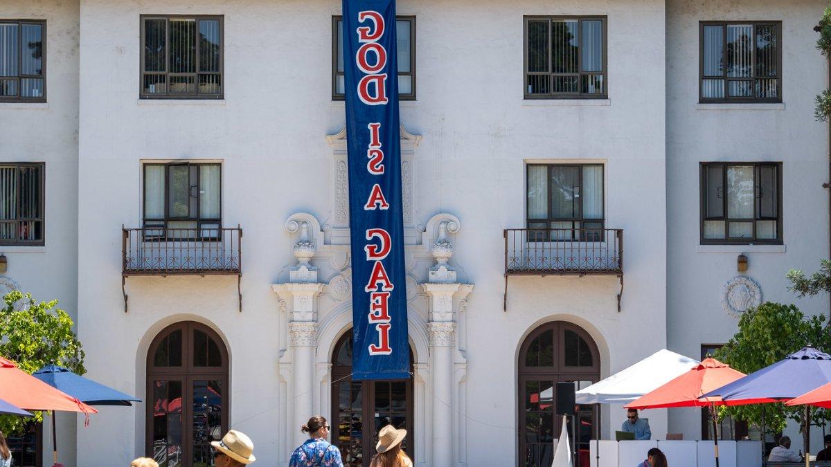 A banner hangs from the three-story dorm reading "God is a Gael"